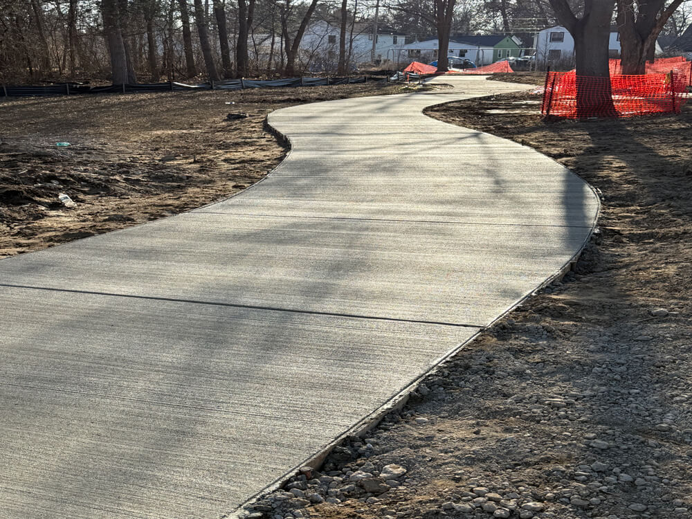 Concrete easement pathway providing access between properties with a smooth, durable finish